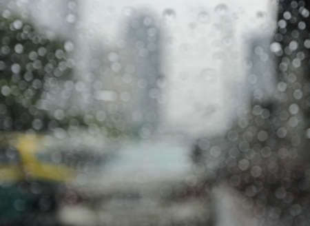 Blurry car seen through wet windscreen in rainy dayの写真素材