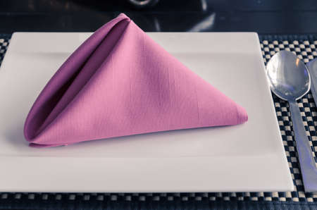 Pink napkin on white plate, table setting in retro filtered effect imageの写真素材