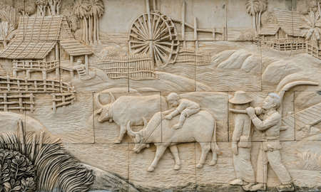 Stone carving of traditional Thai rural culture life in the past, Thailandの写真素材