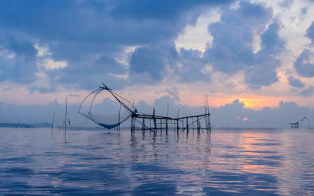 Beautiful sunrise seascape with Chinese fishing nets or shore operated lift nets in Phatthalung, Thailandの写真素材