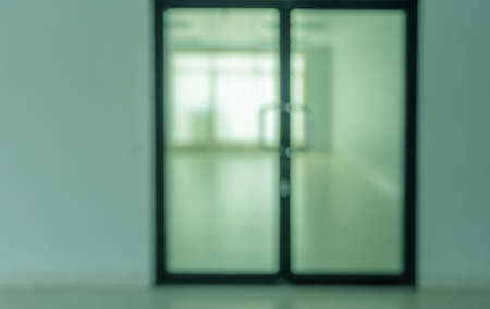 Blurred abstract background interior of empty room with glass doorの写真素材