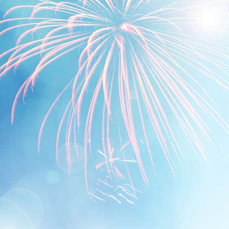Colorful firework on blue bokeh background with lens flare. Abstract New Year holiday or party backgroundの写真素材