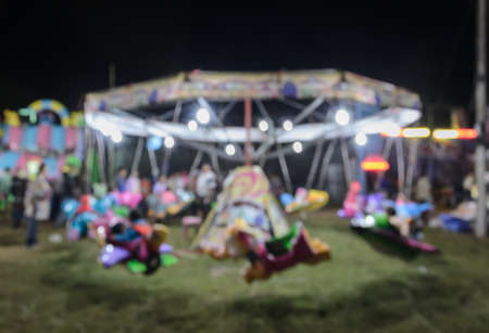 Blur image background of asian travelling funfair with portable  roundaboutの写真素材