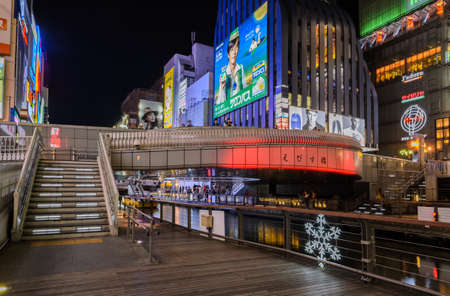 OSAKA, JAPAN - NOVEMBER 23, 2016 : Ebisu bridge and illuminated signboards in Dontonbori, Namba area, Osaka, Japan. Dotombori is popular nightlife and entertainment area in Osaka.のeditorial素材