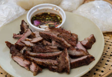 Thai slice grilled pork and Thai style sauce with sticky riceの写真素材