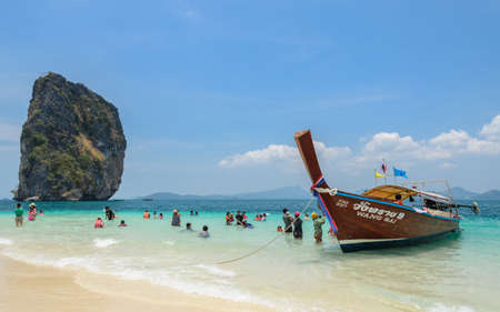 KRABI, THAILAND - APRIL 12, 2016 : Poda Island, white sandy beach with turquoise andaman sea water and long-tailed boat taxi in Krabi province, Thailand.のeditorial素材