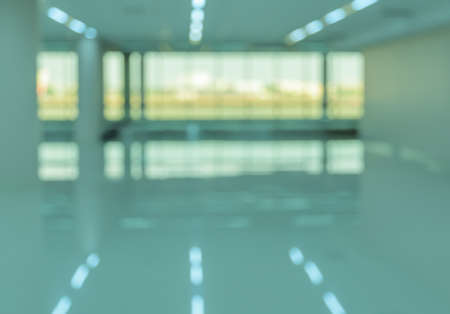Empty modern office building interior with window shadow. Blur abstract image green tone backgroundの写真素材