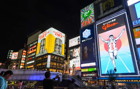OSAKA, JAPAN - NOVEMBER 23, 2016 : The Glico Man billboard and other illuminated signboards in...