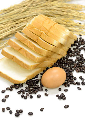 Egg, sliced bread, coffee beans and ears of wheat on white background. Food preparation concept,...
