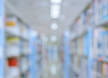 Blurred abstract background of bookshelves and interior of college or university library with textbooks and literatureの写真素材