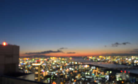 Colorful blurred aerial downtown skyscrapers with city bokeh lights background illuminated at...