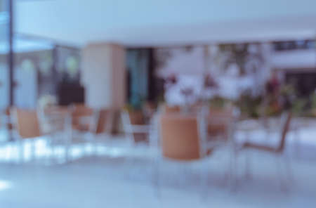 Abstract blur interior coffee shop with empty chairs and tablesの写真素材
