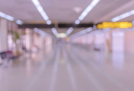 Blurred corridor or walkway of airport terminal interior backgroundの写真素材