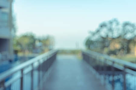 Abstract blurred image of walkway over the outdoor swimming pool for backgroundの写真素材
