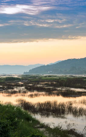 Stunning sunset landscape of the dried up Mekong river in Northeast Thailand. Drought in the river during summer season, greenhouse effect conceptの写真素材