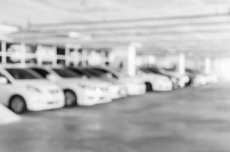 Abstract blurred car background, indoor parking lot in office building or shopping mall or condominium. Black and white color image.の写真素材