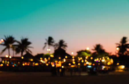 Blurred silhouette beach resort with palm tree at colorful sunset. Vintagetone filtered effectの写真素材