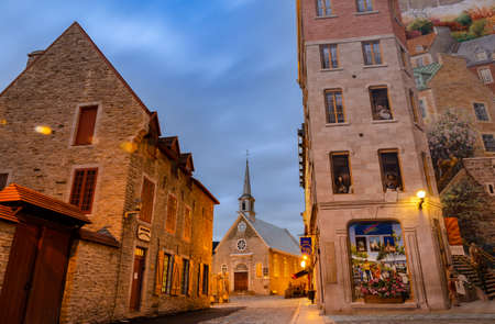 Quebec, Canada - October 16, 2018: Early Morning View of Notre-Dame-des-Victoires Church and murals of Quebec city in Place Royale of Old Quebec city, Canada.のeditorial素材