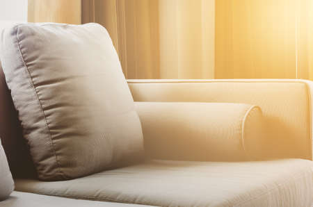 Close up of living room interior with brown fabric sofa and cushions
