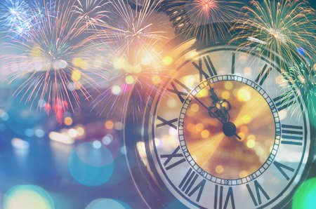 Vintage pocket watch with bokeh lights and colorful fireworks. New year at midnight celebration...