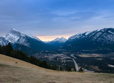 Panorama sunrise view of Mount Rundle and Banff town in Banff National Park in Alberta, Canada. Seen from a vantage point on the road to Mount Norquay.の写真素材