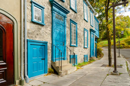 Stone buildings of Townhouse with blue shutters, typical of Old Town Quebec City in Quebec,  Canadaの写真素材