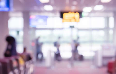 Abstract blurred background of airport terminal interior with travelers walkingの写真素材