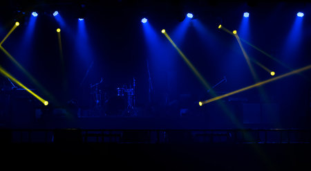Blue and yellow stage spotlights with smoke. Floodlights  of concert sceneの写真素材
