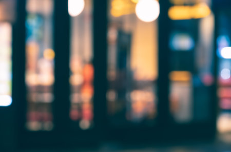 Blurred of coffee shop and restaurant with bokeh coloful night lights backgroundの写真素材