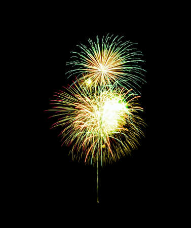 Beautiful colorful fireworks exploding in the night sky, isolated on black background. New year and anniversary concept.の写真素材
