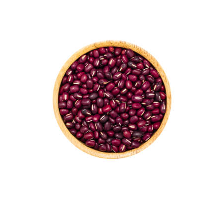 Adzuki red beans (Japanese small red bean) in brown wooden bowl isolated on white background, top view. Healthy organic super food conceptの写真素材