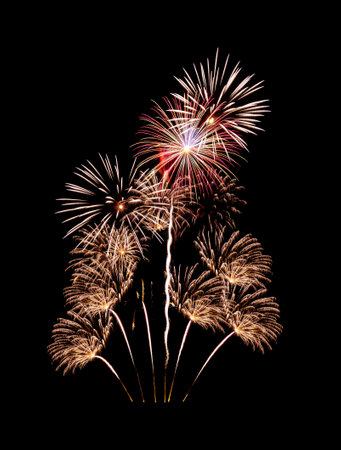 Beautiful colorful fireworks exploding in the night sky, isolated on black background. New year and anniversary concept.の写真素材