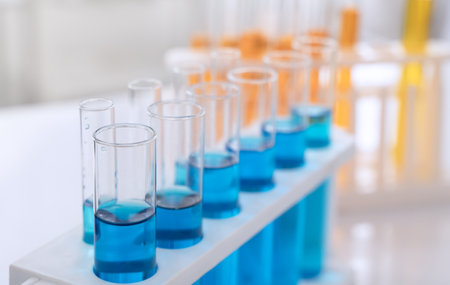 Laboratory test tubes with blue and orange chemical liquid, science and medical research and development conceptの写真素材