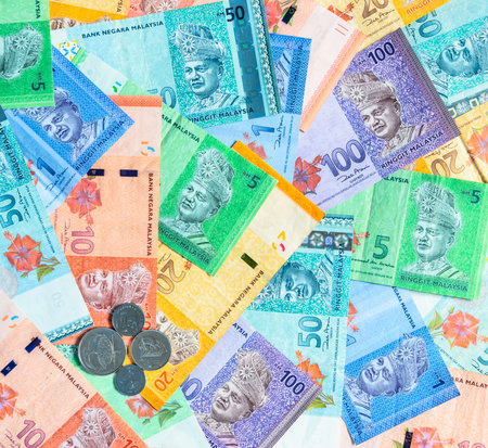 Malaysia currency of Malaysian ringgit banknotes and coins background. Sen coins of fIve, ten, twenty and fifty on paper money of one, five, ten, twenty, fifty and hundred ringgit notes.の写真素材