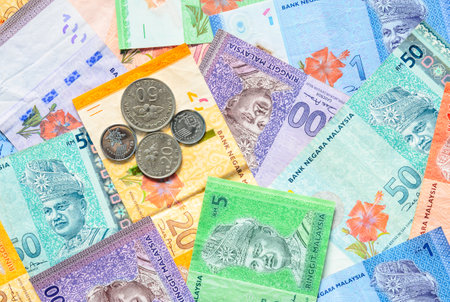 Malaysia currency of Malaysian ringgit banknotes and coins background. Sen coins of fIve, ten, twenty and fifty on paper money of one, five, ten, twenty, fifty and hundred ringgit notes.の写真素材