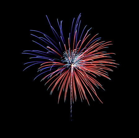 Beautiful festive blue and red fireworks display on night sky. New year and anniversary concept.の写真素材