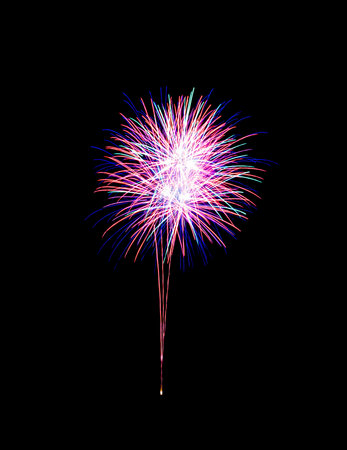 Beautiful colorful fireworks exploding in the night sky, isolated on black background. New year and anniversary concept.の写真素材
