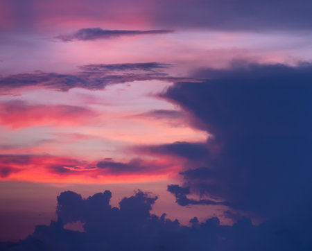 Background of colorful dramatic sunset with twilight color sky and cloudsの写真素材