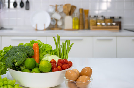 Healthy foods of fresh vegetables, fruits, eggs and pineaple juice on white table in home kitchen . Home healthy lifestyle conceptの写真素材