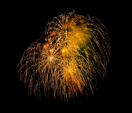 Festive golden fireworks display isolated on black background for celebration and anniversaryの写真素材