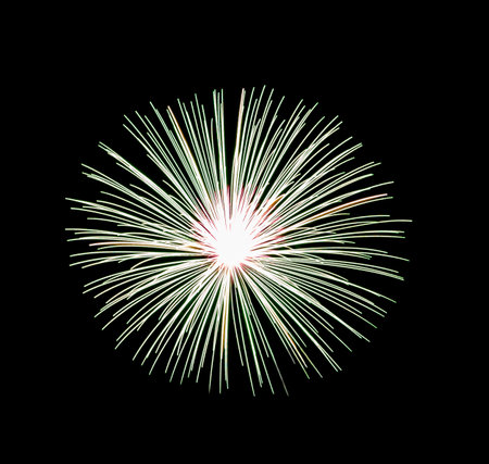 Green fireworks display isolated on black background for celebration and anniversaryの写真素材