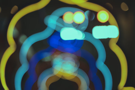 Blurry colorful Christmas bokeh lights festive backgroundの写真素材