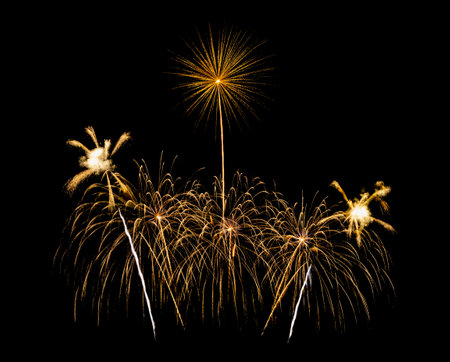 Golden fireworks display isolated on black background for new year celebration and anniversaryの写真素材