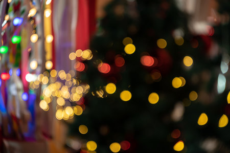 Blurry colorful Christmas bokeh lights festive backgroundの写真素材