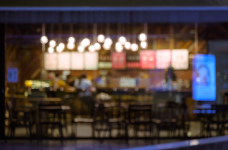 Blurred of coffee shop and restaurant with bokeh coloful night lights backgroundの写真素材