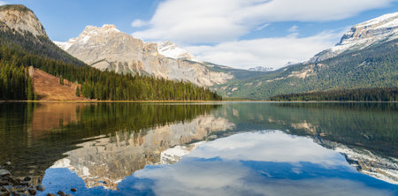 Scenic view of Emerald Lake in Yoho National Park with pine forest and snow-capped mountain with reflected in crystal clear water in Alberta, Canadaの写真素材