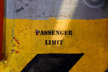 warning sign passenger limit on vessel floor with black and yellow color.の写真素材
