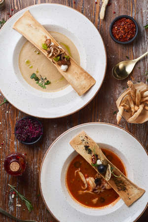 mushroom and tomato cream soup on a wooden tableの写真素材