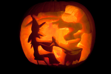 glowing halloween pumpkin with witchの写真素材