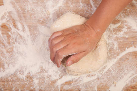kneading scone dough on wooden table